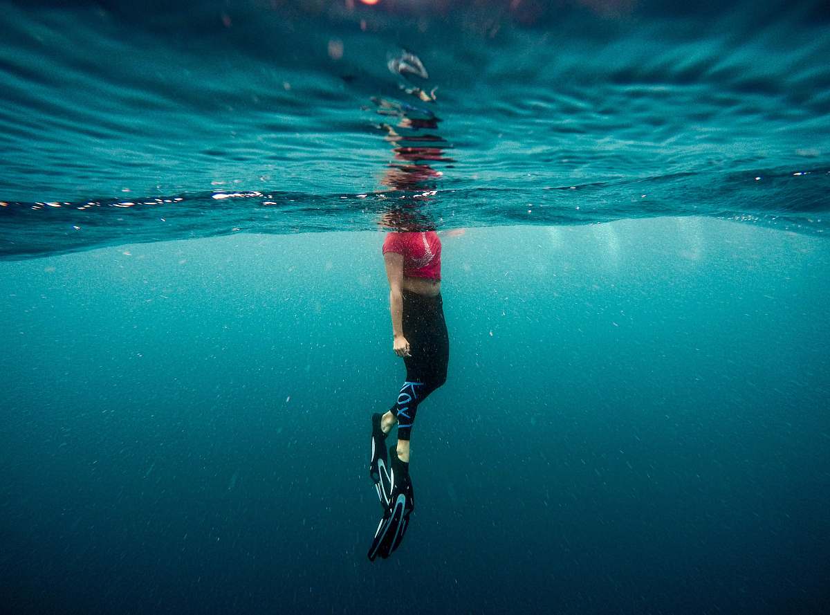 blue photography of person under water person