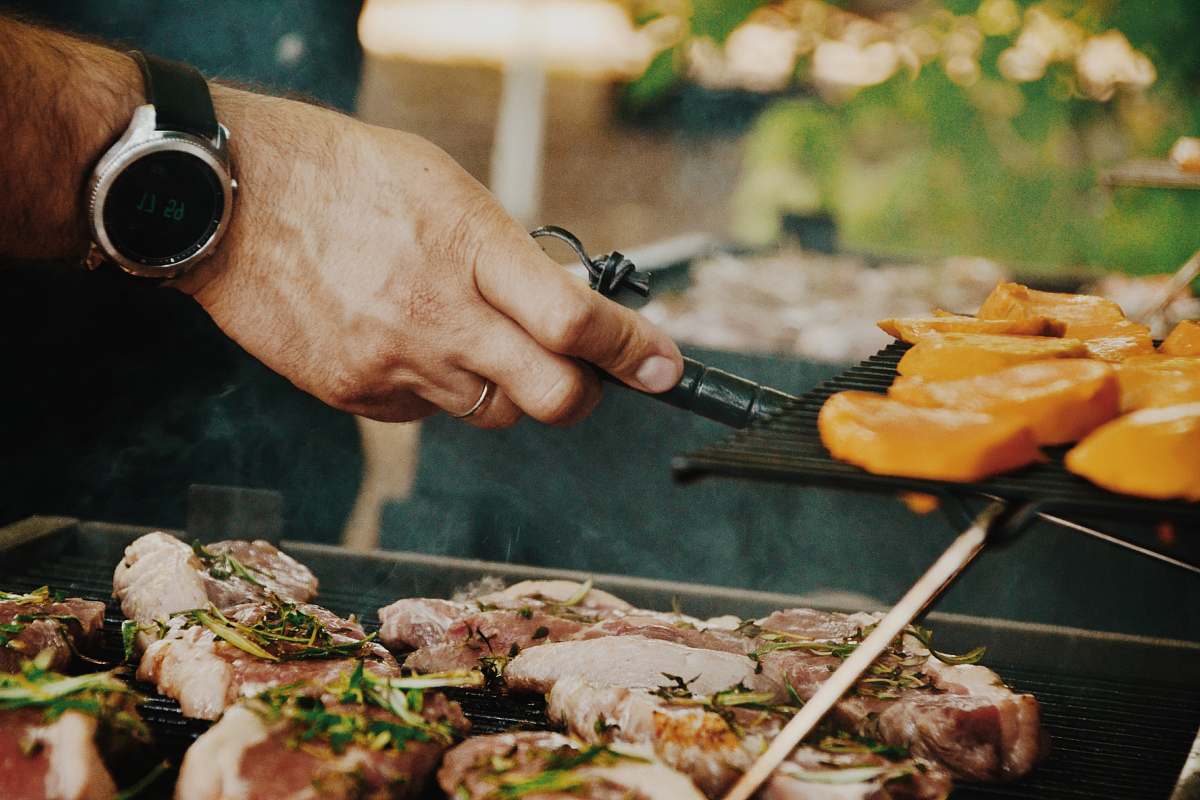 food person grilling meat sandwich