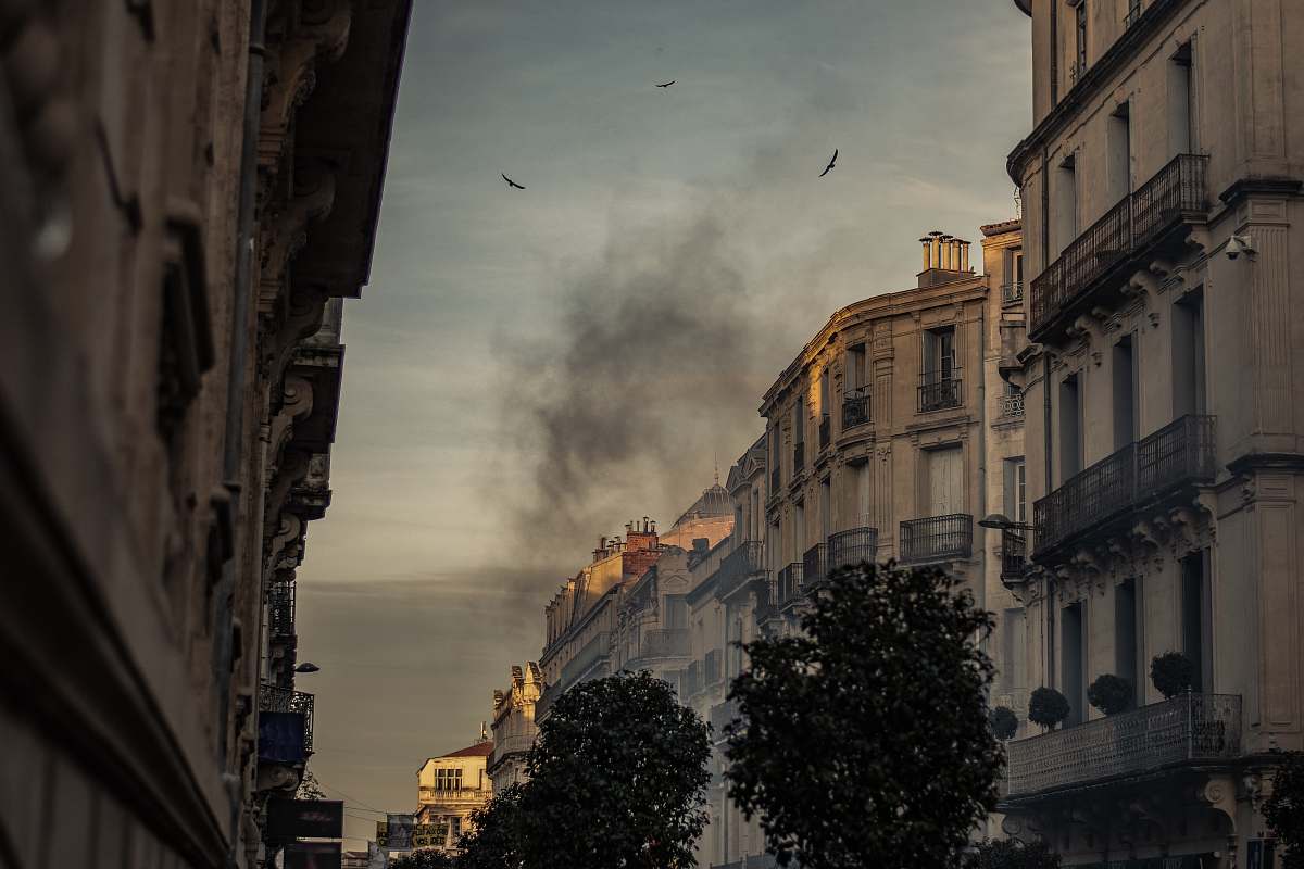 city white concrete building with black smoke outdoor urban