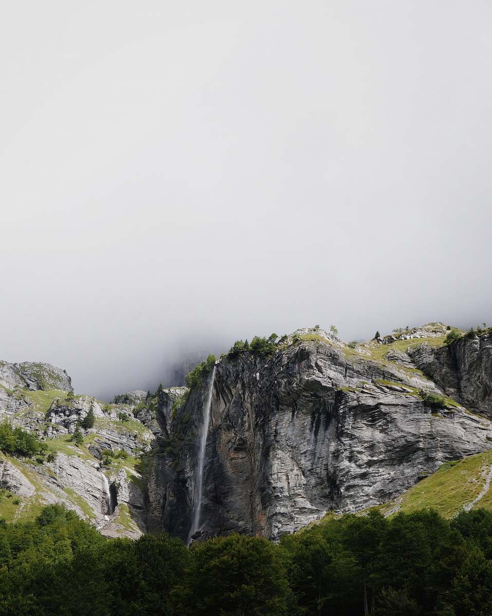 france mountains covered with green trees under cloudy sky during daytime outdoors