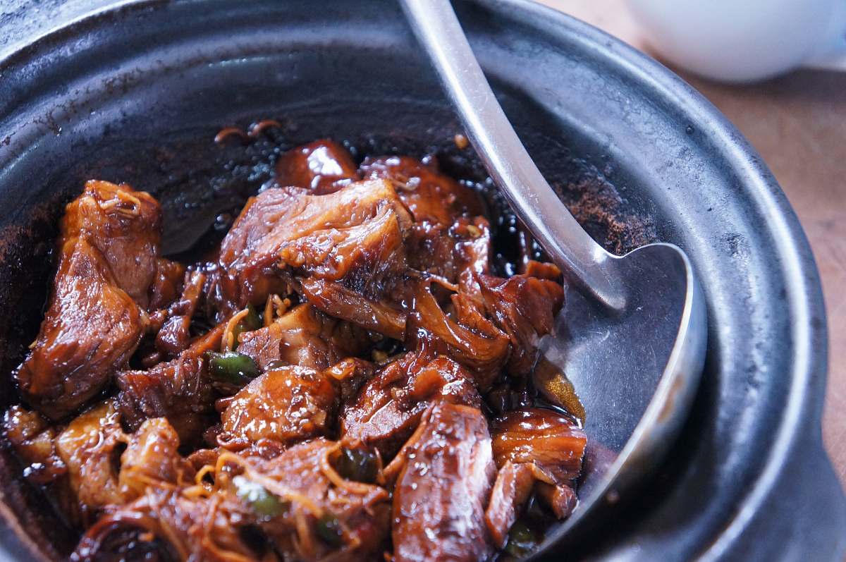 bbq meat with sauce in black bowl meat