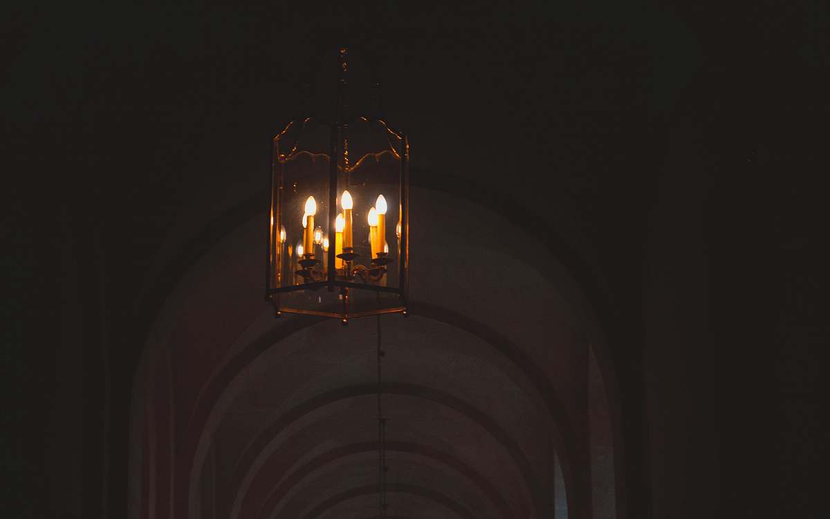 candle turned on chandelier versailles