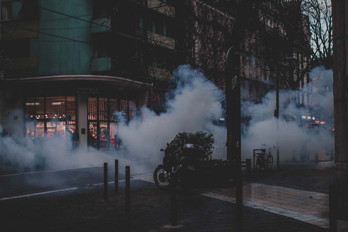 smoke black and gray concrete building during night time motorcycle