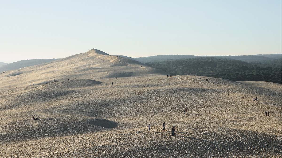 nature people gathered on desert under gray sky sand