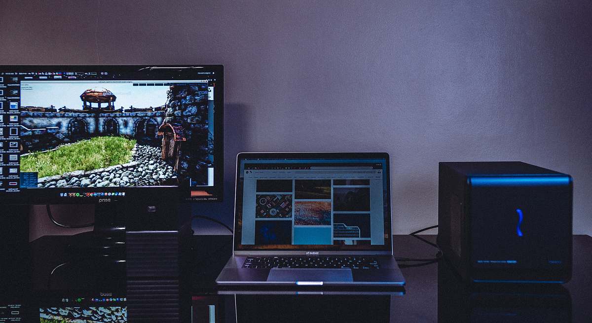 monitor turned-on MacBook beside monitor screen