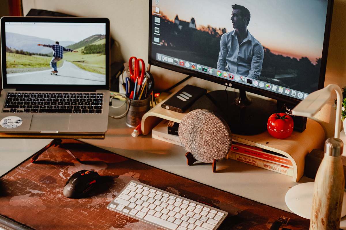 table MacBook Pro and black flat screen monitor furniture