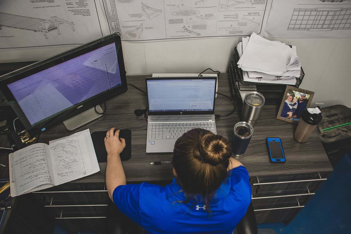 table woman using laptop computer furniture