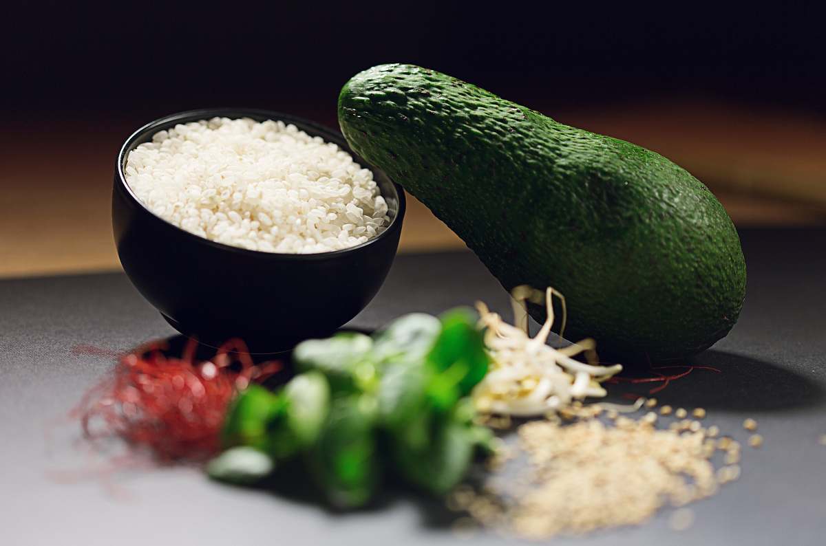 plant avocado fruit near cooked rice and sliced green bell pepper avocado