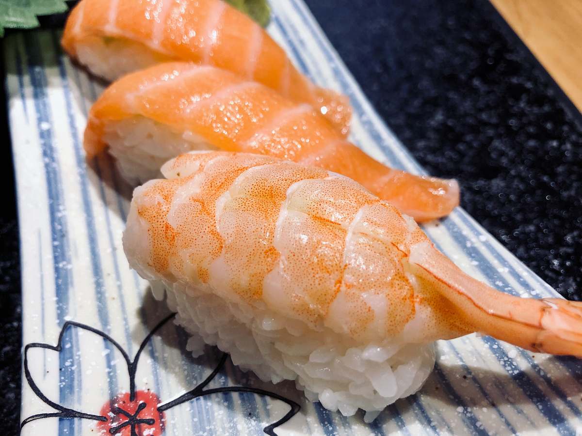 bread orange and white sushi on white plastic container sushi