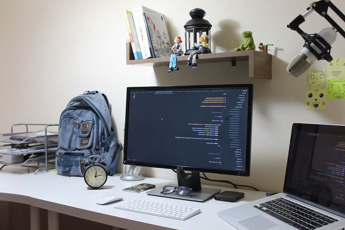 table turned-on flat screen computer monitor desk