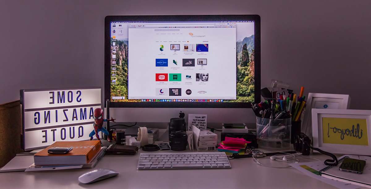 desk turned-on flat screen monitor on table keyboard