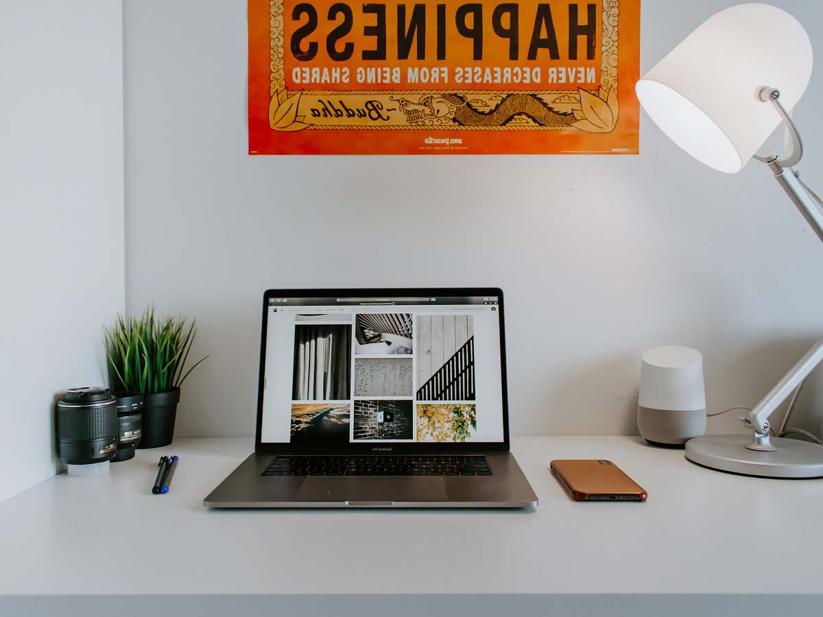 table turned-on laptop near desk lamp desk
