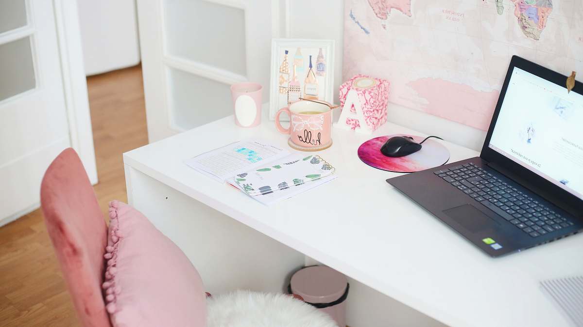 table turned-on laptop on desk near open door desk