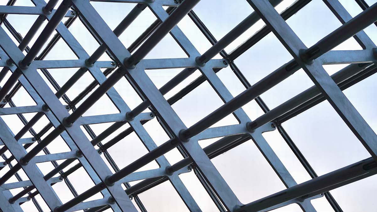 building photo of gray metal structure during daytime skylight