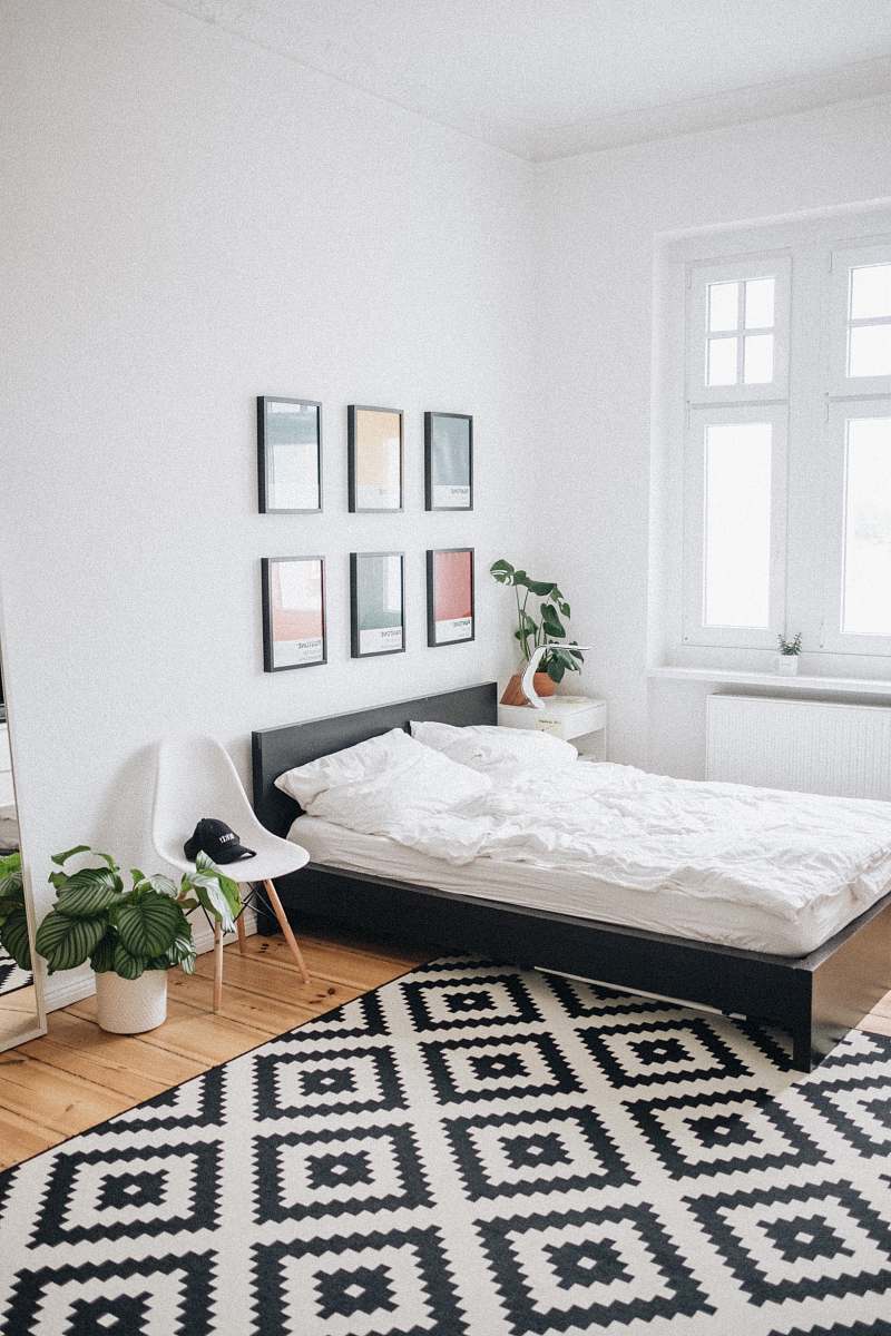 interior black platform bed with white mattress inside bedroom germany