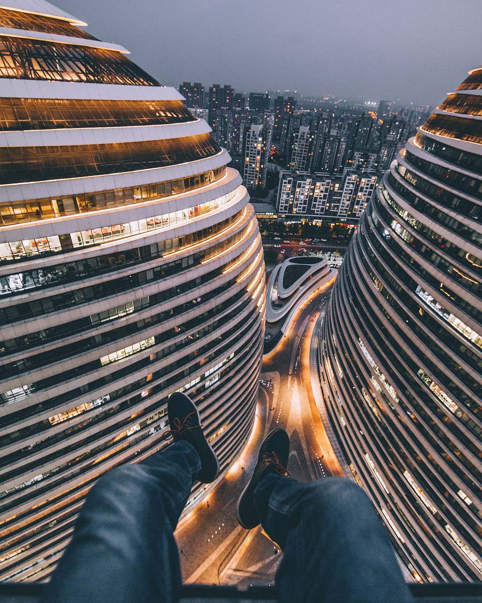 city person seating on building urban