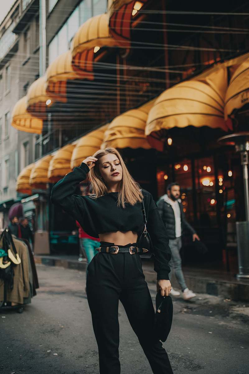 clothing woman standing near people and building during day apparel