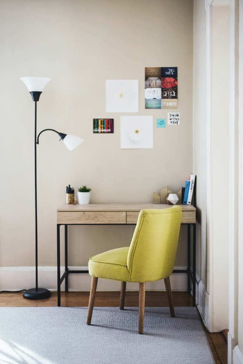 furniture black 2-light torchiere beside brown wooden-top desk with black steel frame chair