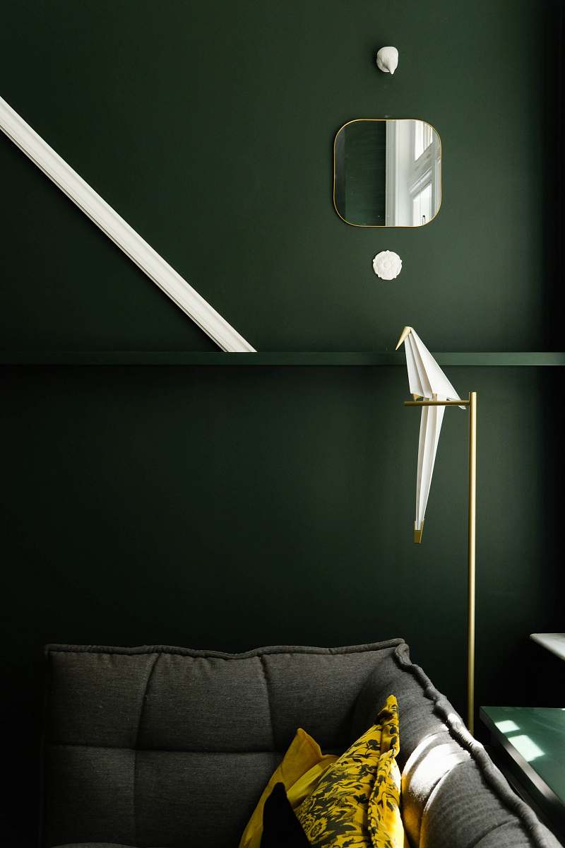 human square framed mirror over gray sofa person