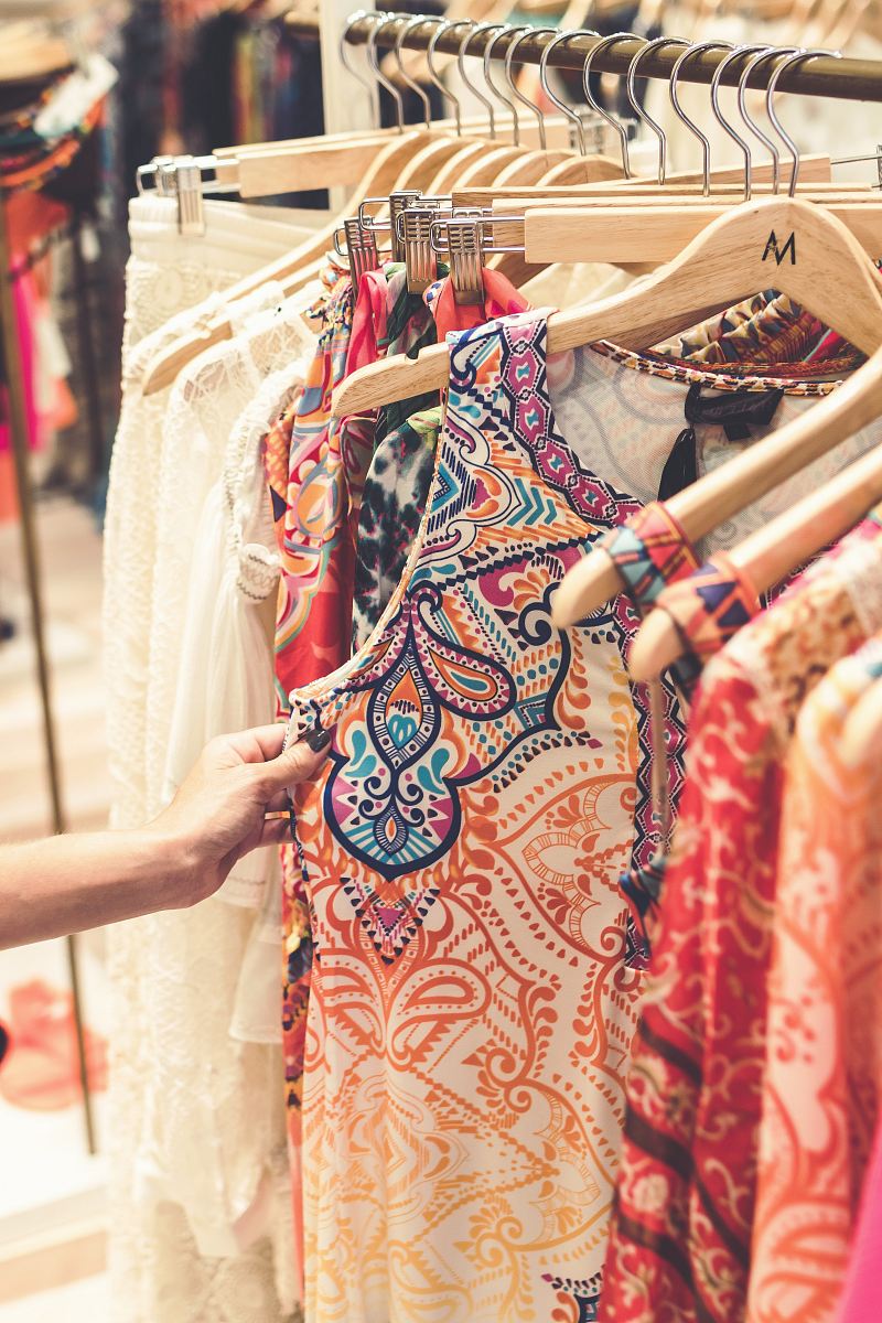 a woman shopping in a clothing store