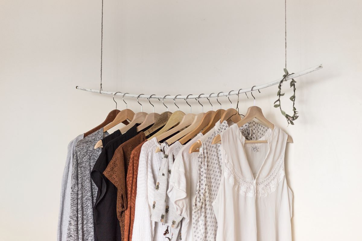 assorted clothes in wooden hangers