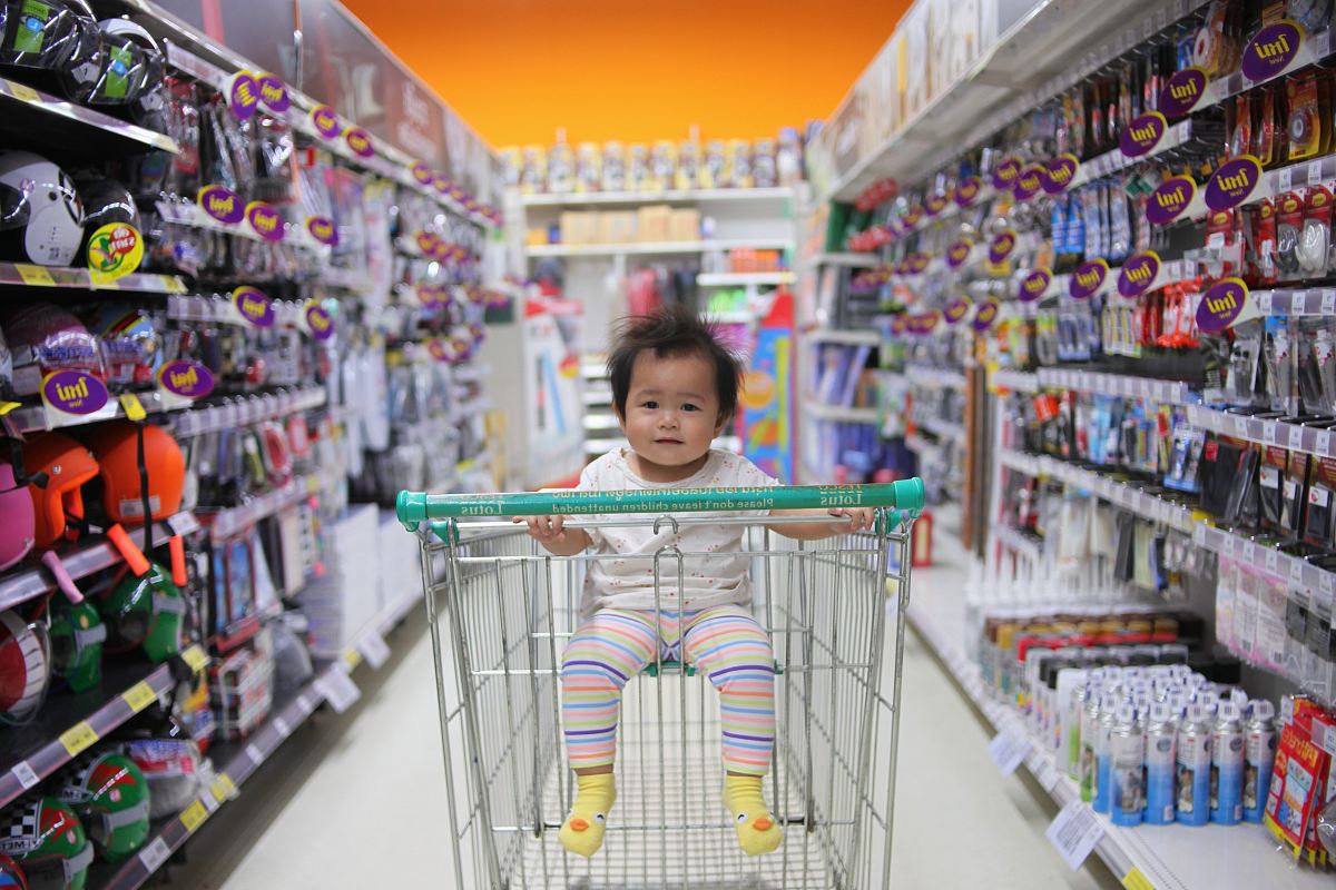 baby on white shopping cart