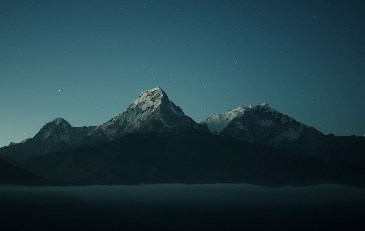 silhouette of mountains during nigh time photography