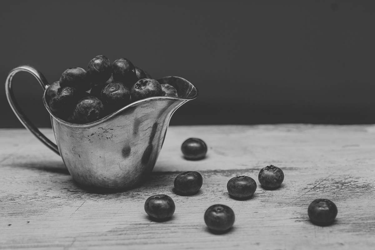 black-and-white pitcher filled with berries grey
