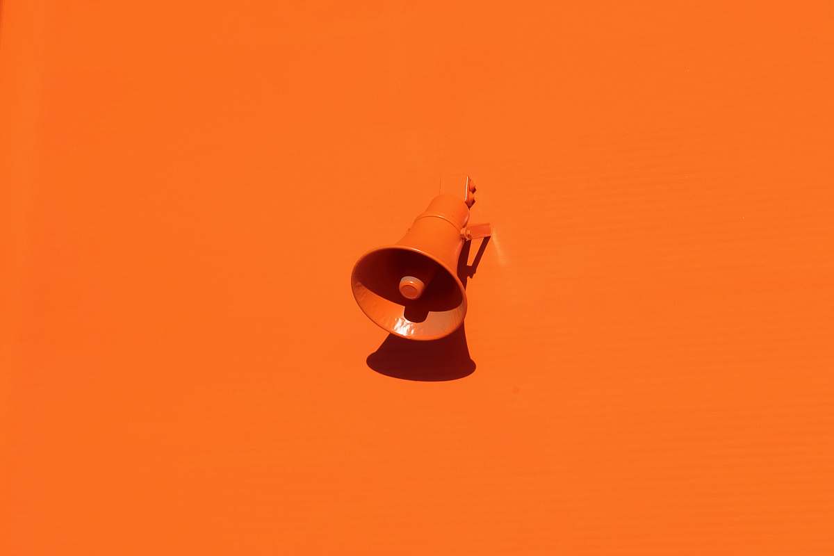 color orange megaphone on orange wall background