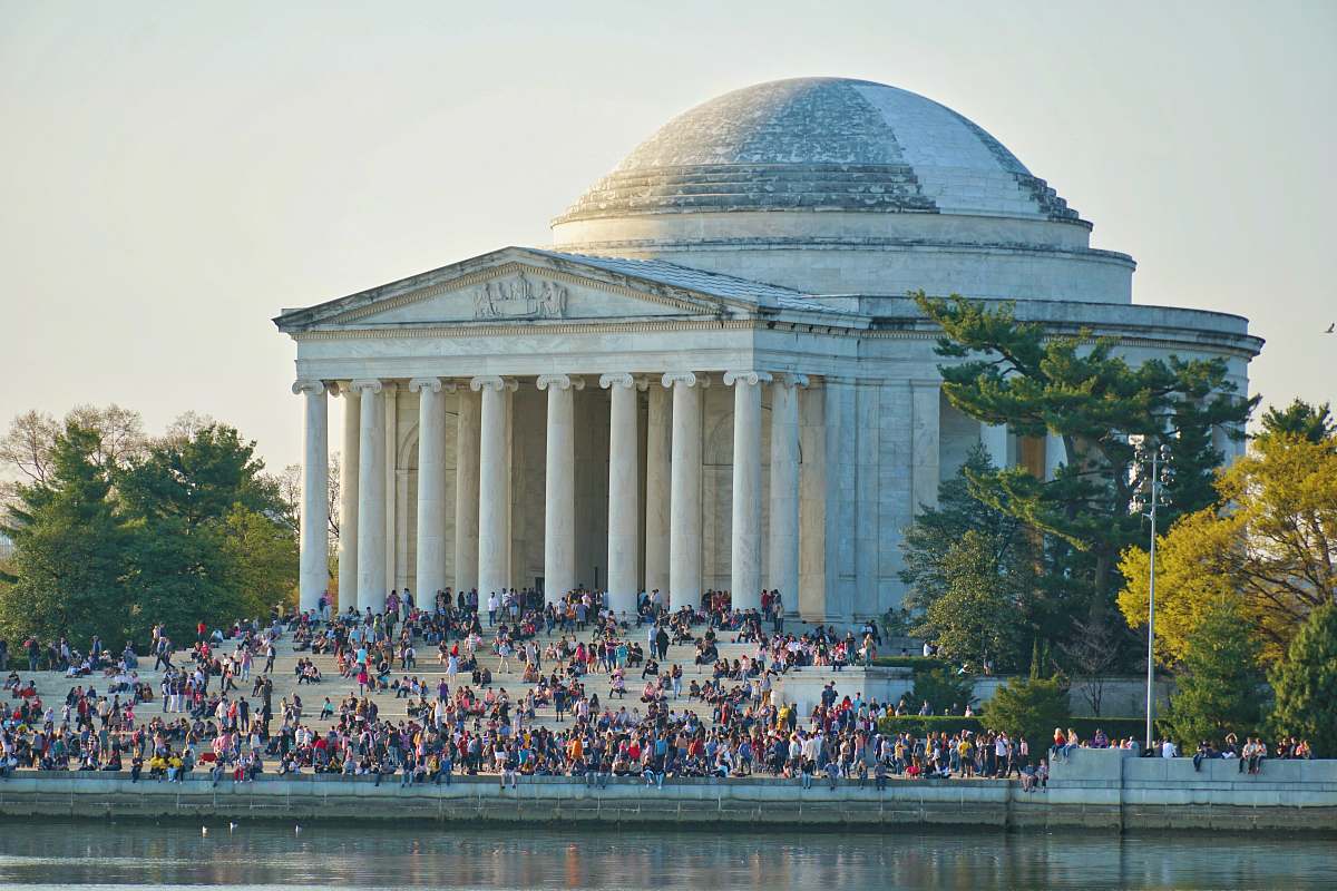 architecture people gathering near white concrete building person