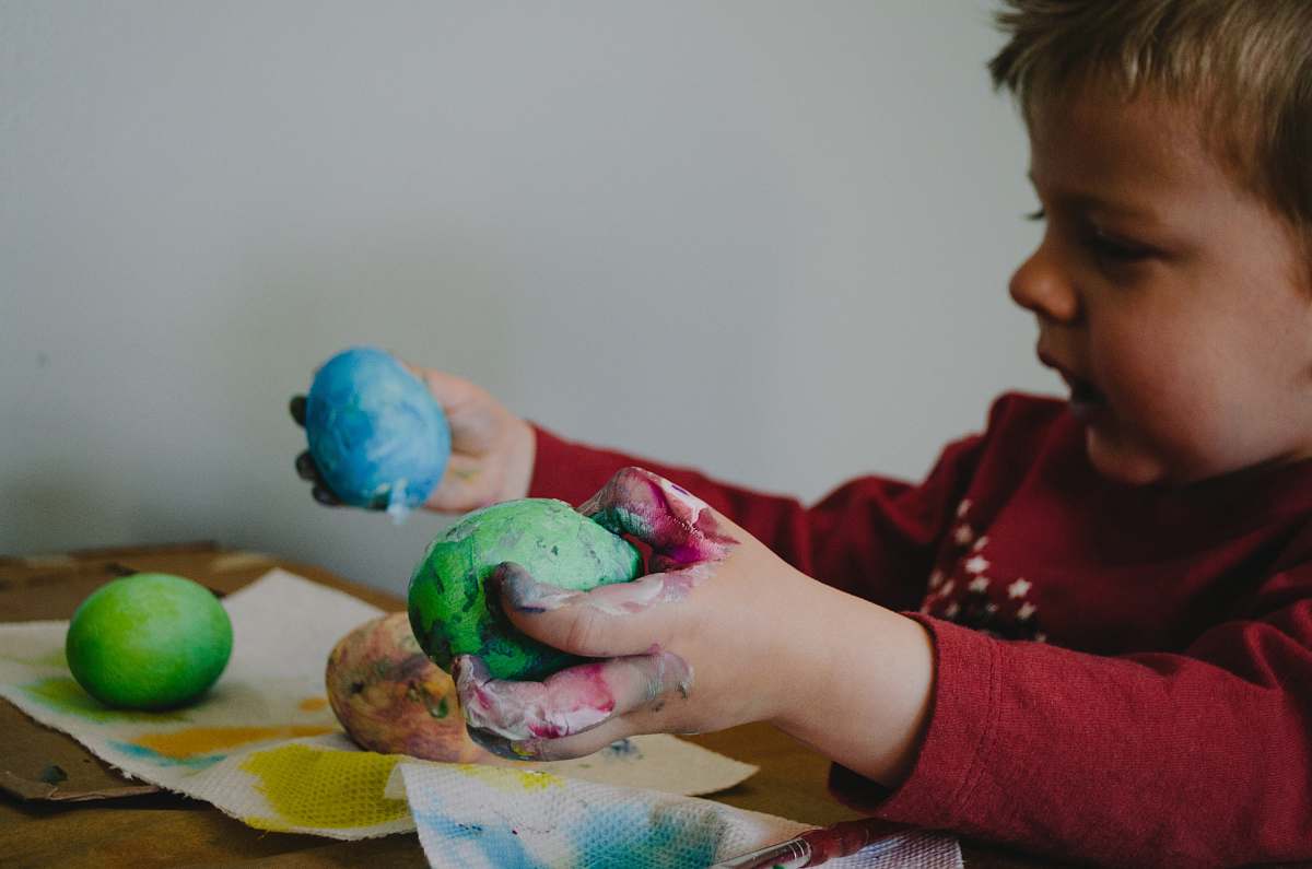 people boy holding blue and green painted egg shells person