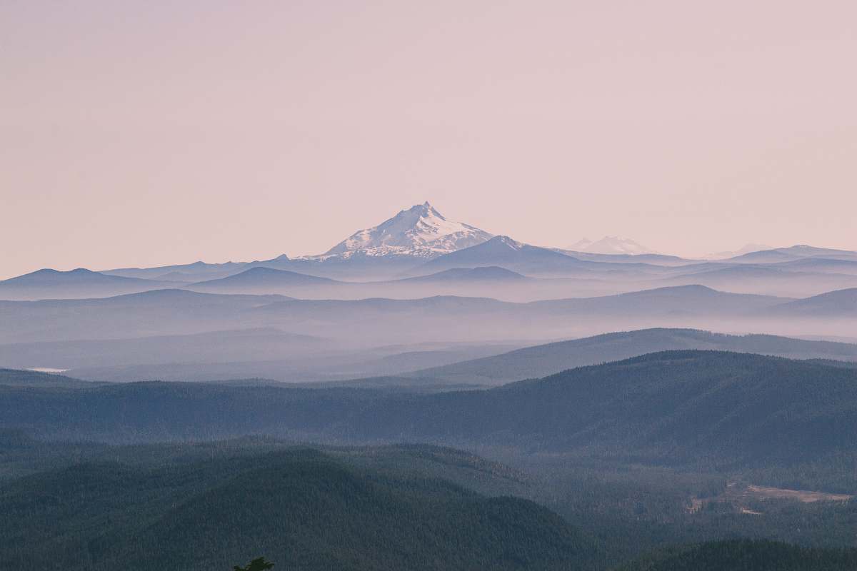 mountain aerial photography of green field viewing summit of mountain grey
