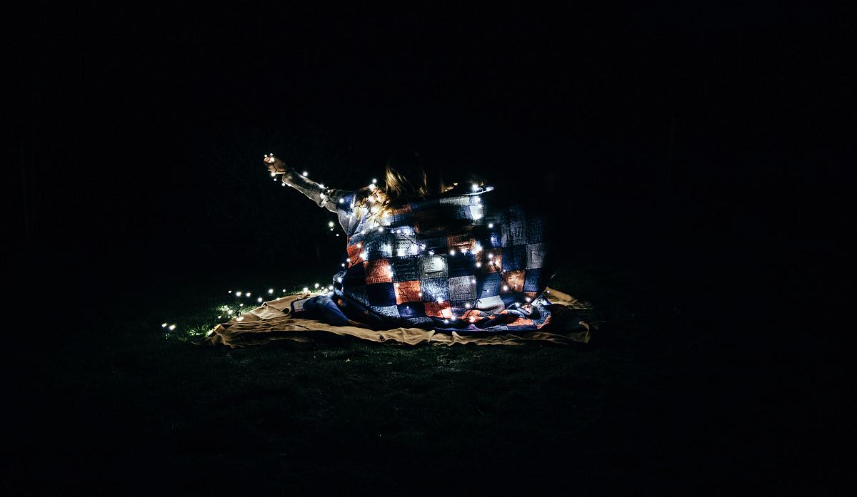 a small house in the dark with lights on it
