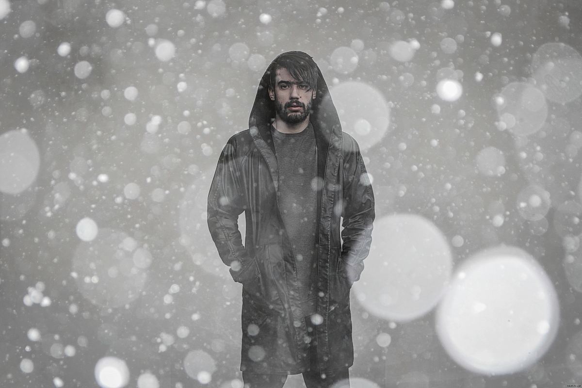 bokeh photography of man wearing coat