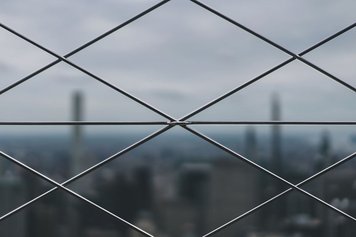 closeup photo of gray metal mesh-link fence