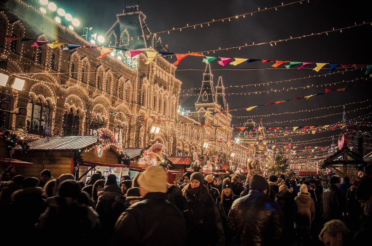 event photography of people gather outside light strings covered building