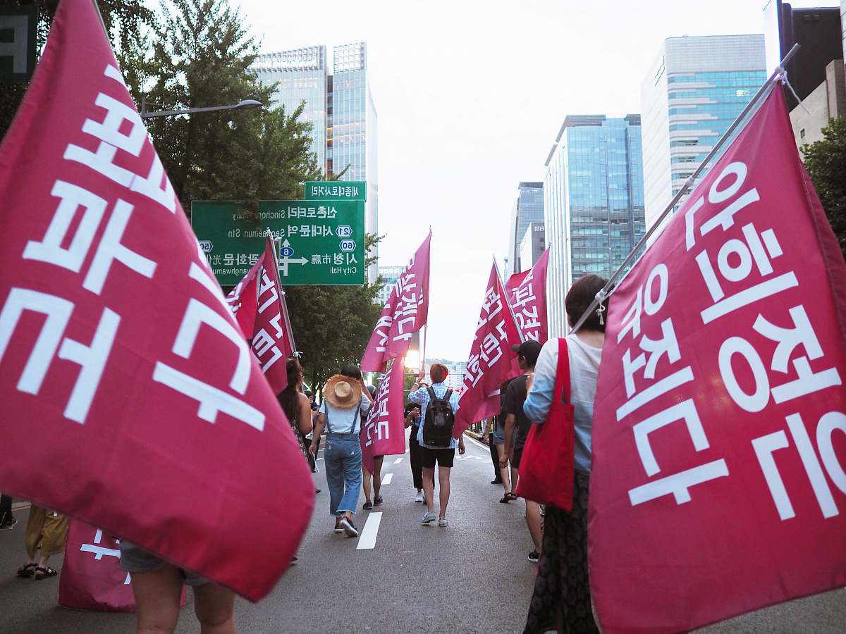 text people on road with banners during daytime banner