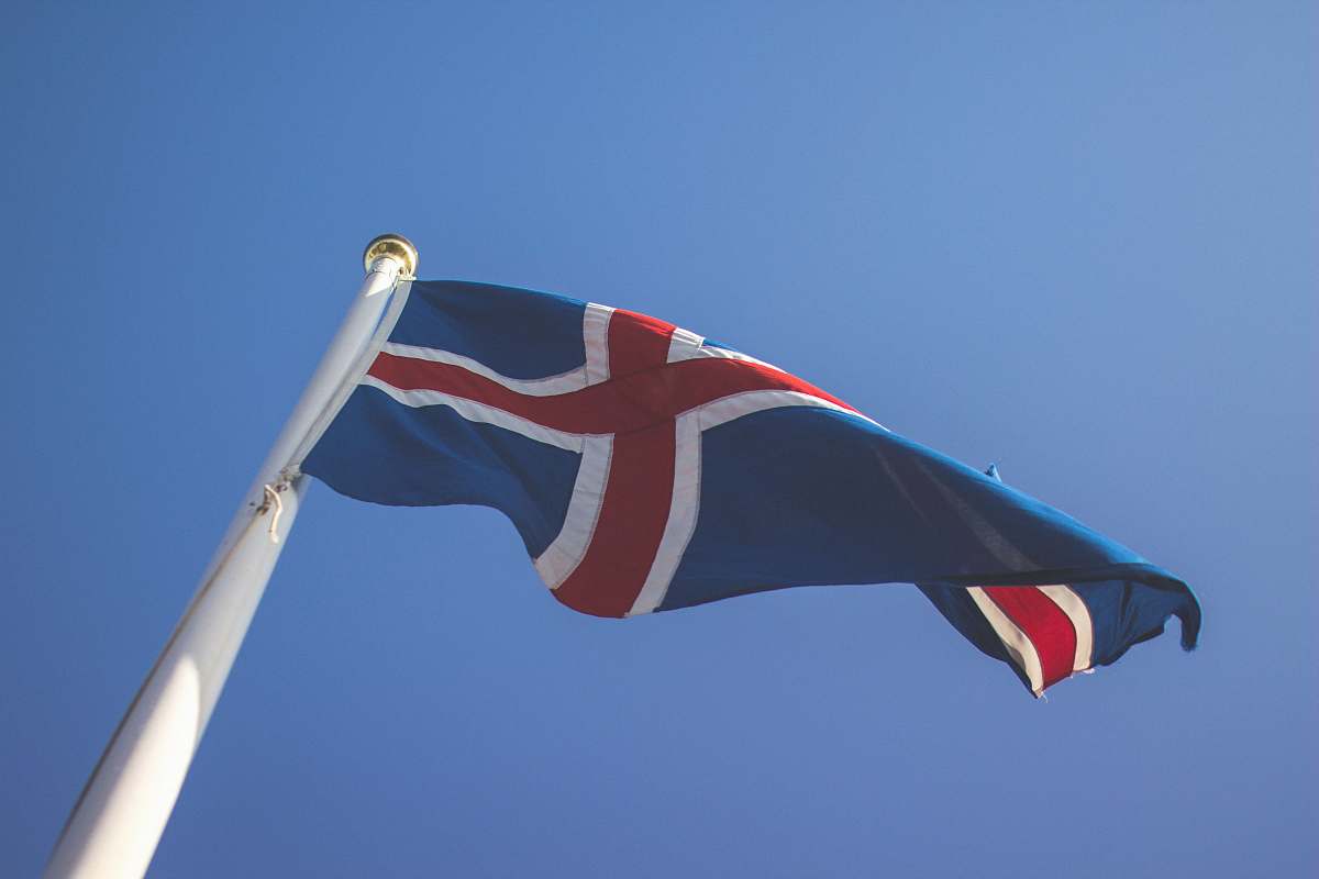 emblem waving blue and red country flag sky