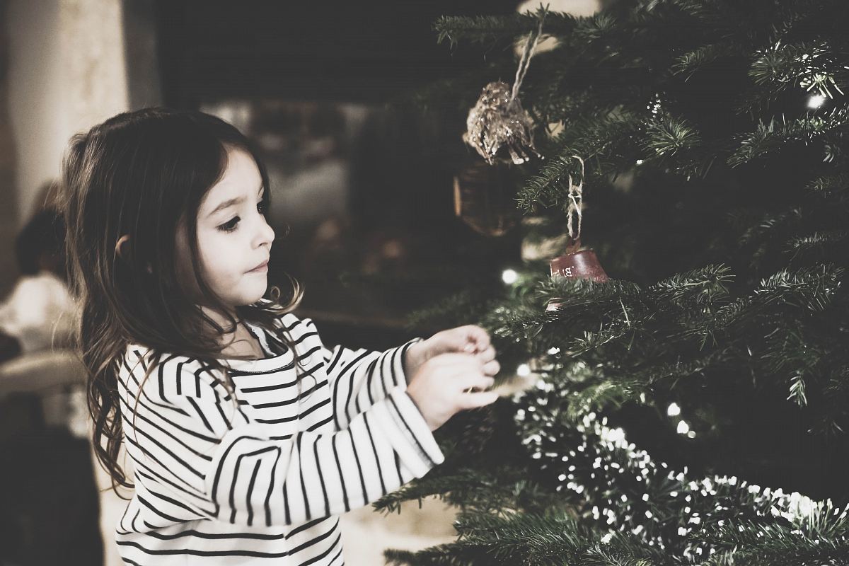 girl decorating the Christmas tree