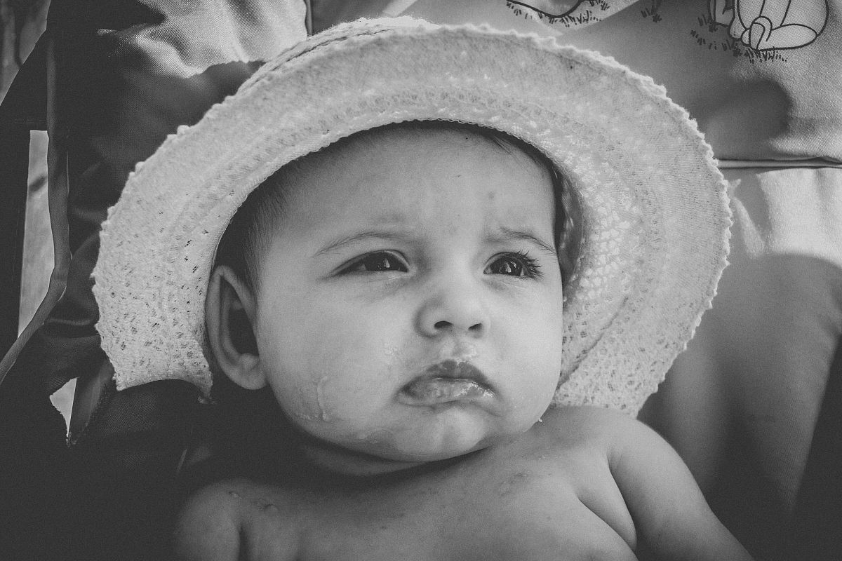 grayscale photography of baby wearing hat