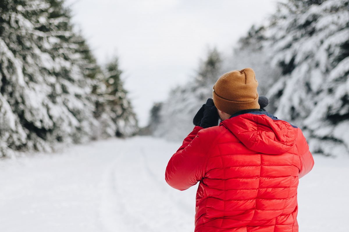 man wearing bubble jacket in snow