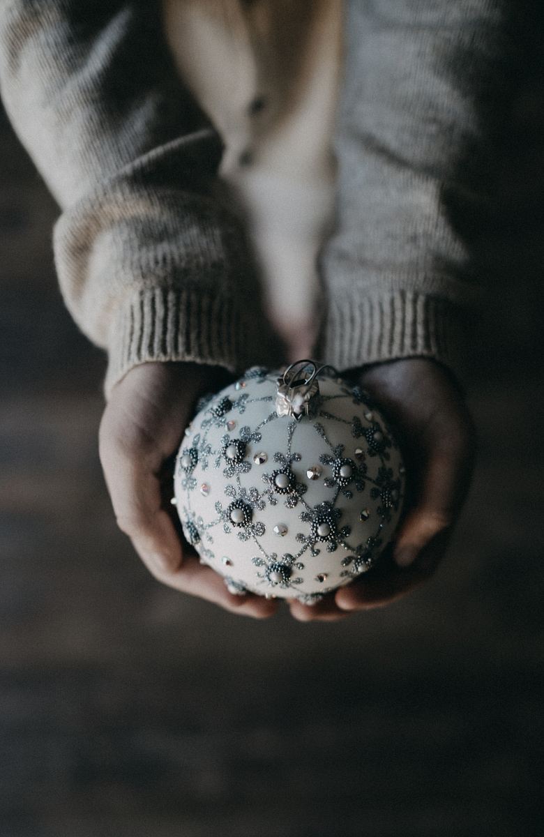 person holding bauble ball