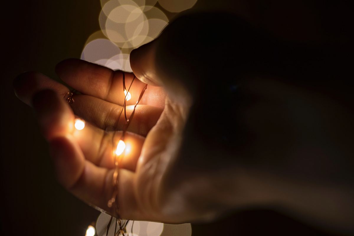 person holding lace with yellow lights