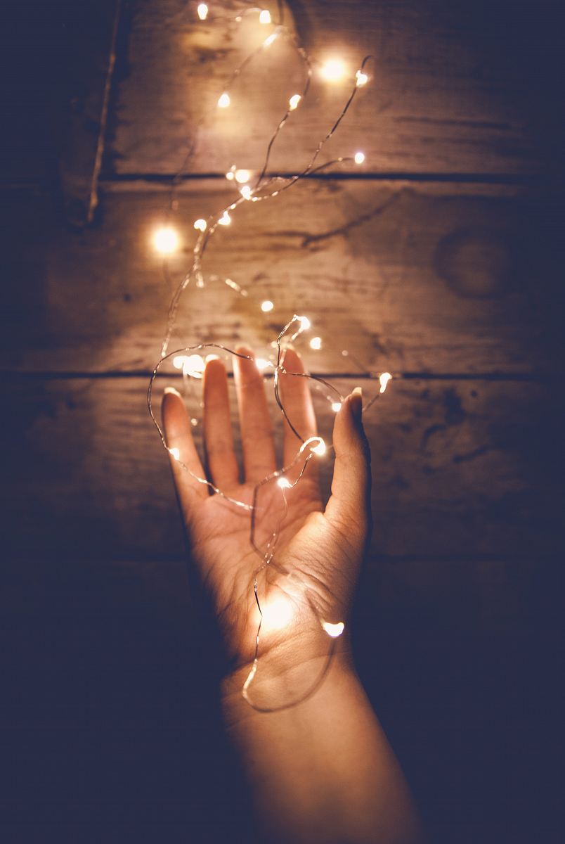 person holding white string light