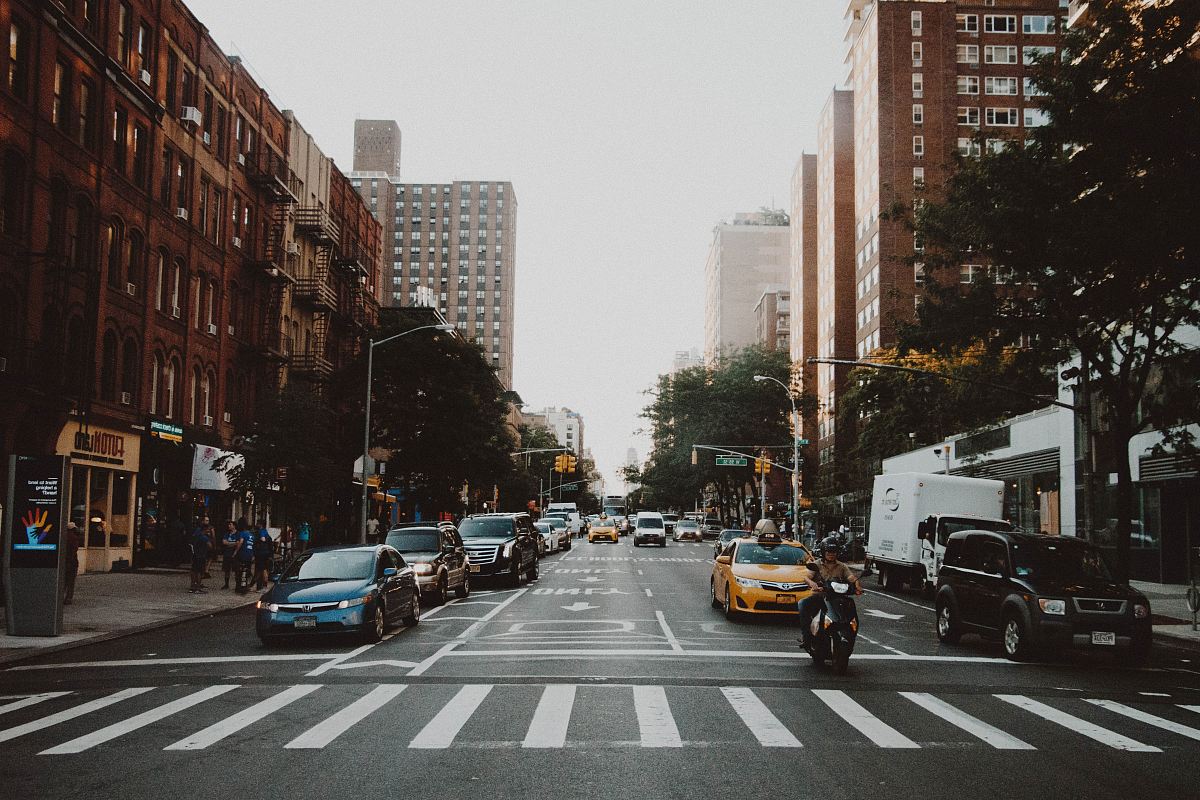 photo of cars on road near city building