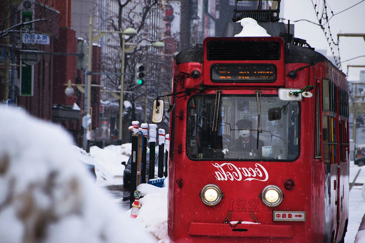 red Coca-Cola tram during snow