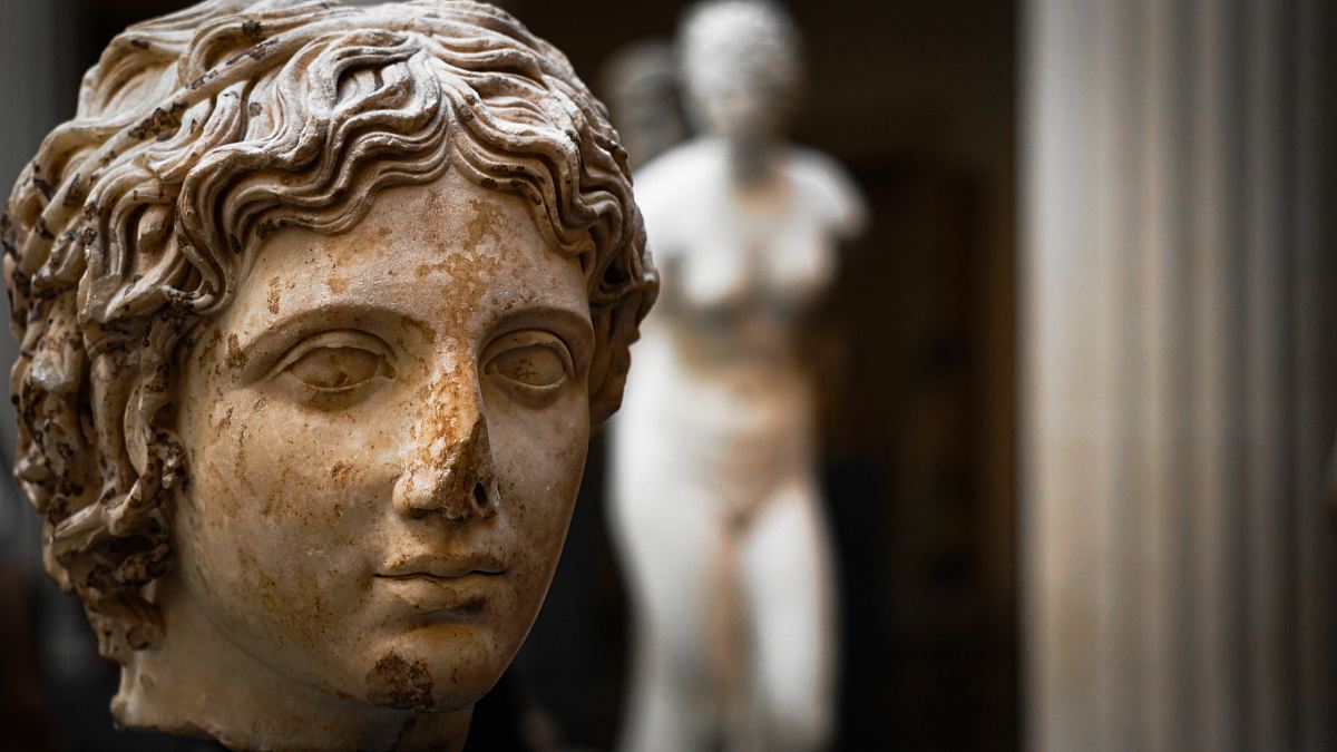 selective focus photography of woman statue