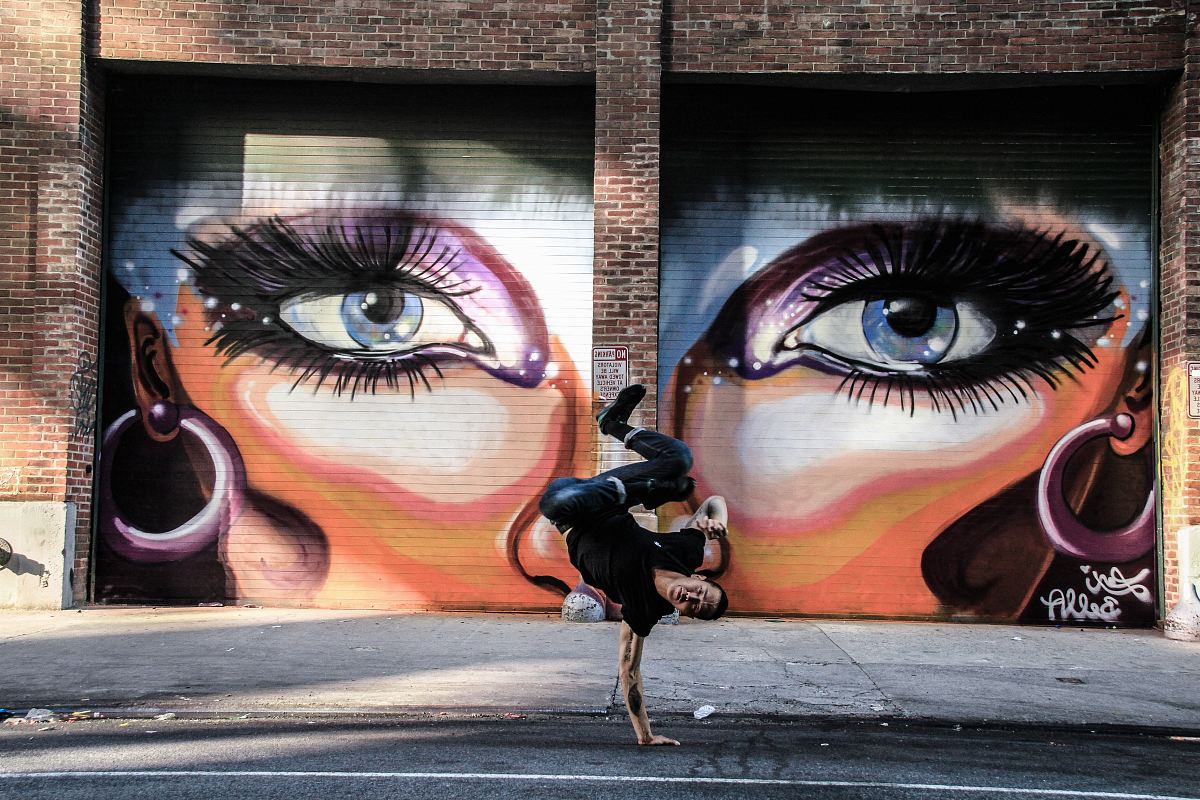 shallow focus photo of man doing hand stand