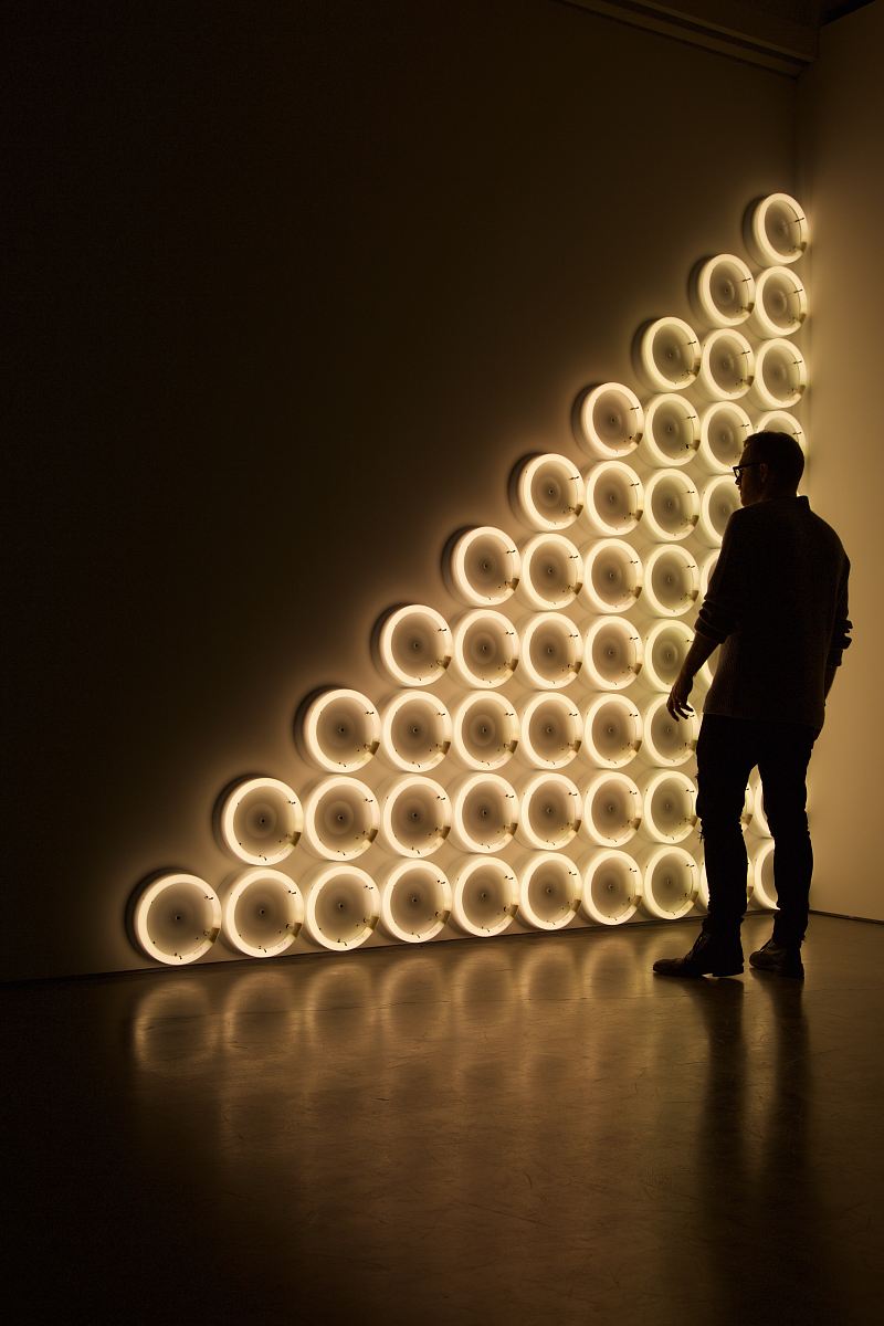 silhouette photo of man standing in front of LED wall lights \