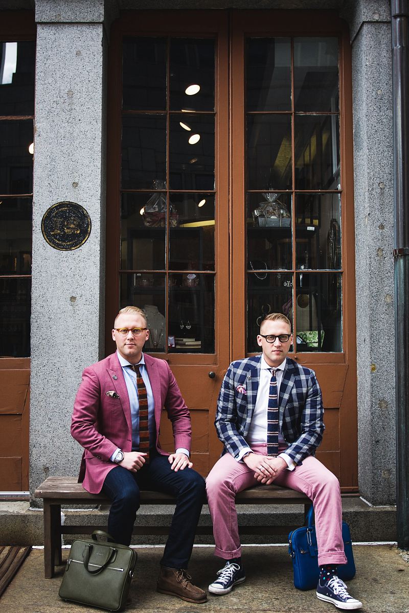 two man in formal suit sitting on bench chair